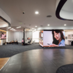 A modern showroom interior with digital displays, appliances, and work zones at the Samsung Business Experience Studio.