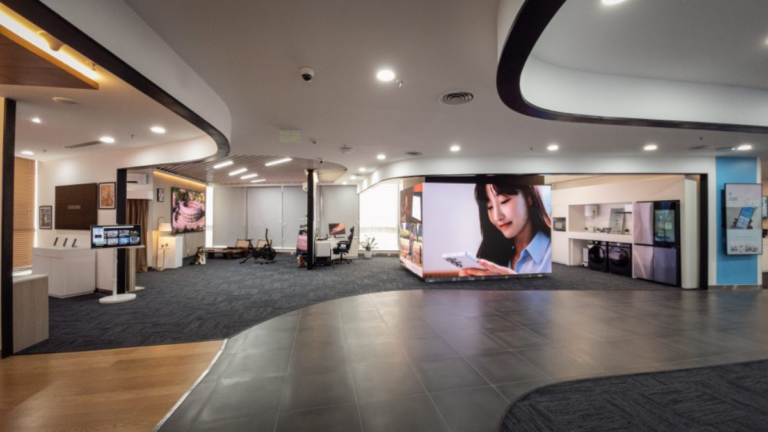 A modern showroom interior with digital displays, appliances, and work zones at the Samsung Business Experience Studio.