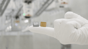 A white gloved hand holding two Samsung HBM4E memory chips showing top and bottom details for India datacentres.