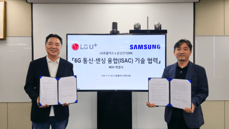 Two executives hold signed documents before a screen displaying LG Uplus and Samsung logos for a 6G network partnership.