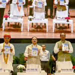 JP Nadda and Shivraj Singh Chouhan holding SEHAT Mission booklets on stage at a launch event in Delhi for India nutrition