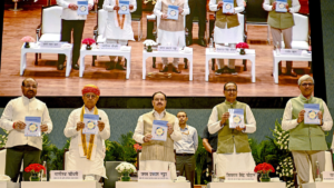 JP Nadda and Shivraj Singh Chouhan holding SEHAT Mission booklets on stage at a launch event in Delhi for India nutrition