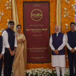 PM Modi and officials stand by a marigold-framed plaque at the Sindhu Hospital inauguration in Hyderabad.