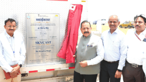 Union Minister Dr. Jitendra Singh unveils the SkyCast plaque with three officials on the Delhi airport tarmac.