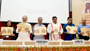 Dharmendra Pradhan and officials holding the SMC Guidelines 2026 booklets at Vigyan Bhawan for the school policy launch.
