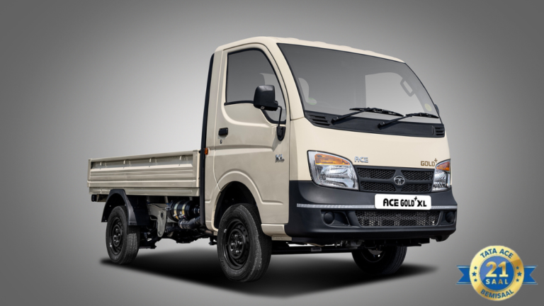 Cream-coloured Tata Ace Gold+ XL mini-truck with an 8-foot cargo bed and a 21-year anniversary seal on a grey background.