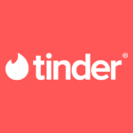 White Tinder logo, with flame icon and wordmark, centered on a warm coral-red background for its India launch context.