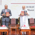 Amit Shah and Tushar Mehta hold two legal humour books at Bharat Mandapam during the New Delhi launch.