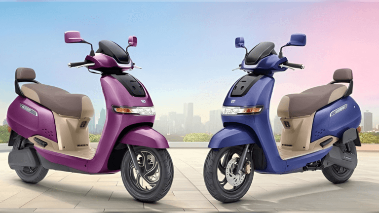 Purple and blue TVS iQube S electric scooters parked side-by-side against a city skyline for the 2026 India launch.
