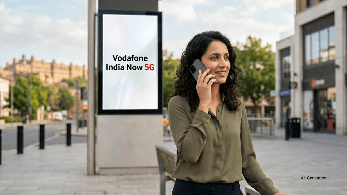 New network footprint reaches Gwalior and ten eastern cities 1 A woman talks on a smartphone next to a street billboard reading Vodafone India Now 5G, representing regional telecom cove...