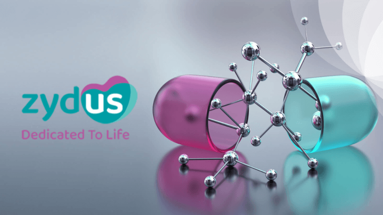 Zydus logo beside an open pink and teal medicine capsule and silver molecular structure. Oncology.