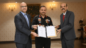 Two men in business suits and an Indian Army officer hold an open signed agreement folder for Air India.