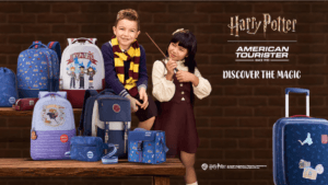 Boy and girl with a wand posing by Harry Potter backpacks and a blue trolley suitcase from the new India collection.