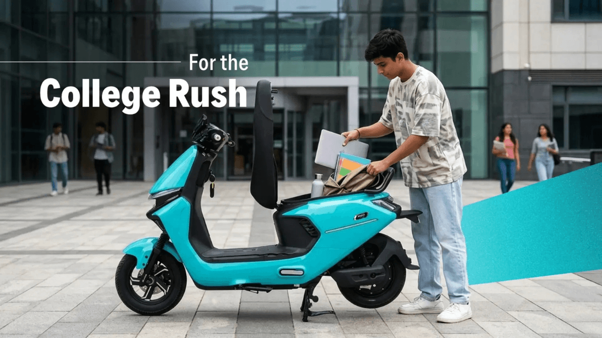 At ₹69,499 this scooter skips RTO queues entirely 2 A student loading a laptop into the open under-seat boot of a cyan Ampere Reo VYB scooter on a college campus plaza.