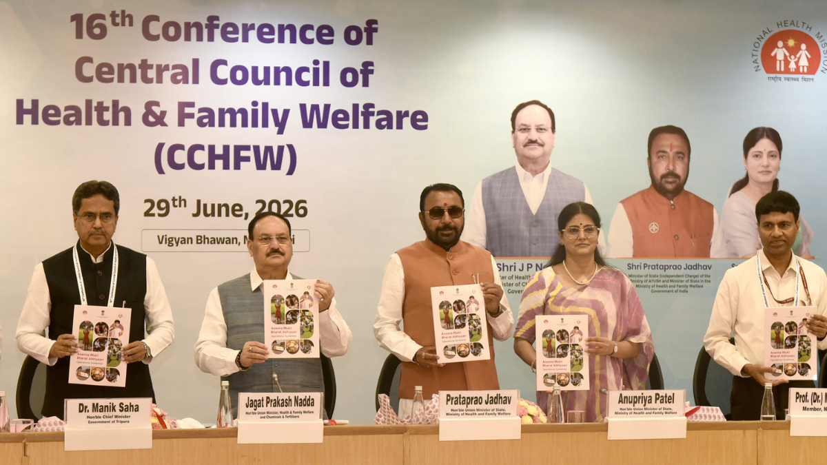 Five health officials stand left to right holding the Anemia Mukt Bharat Abhiyaan operational guidelines book.