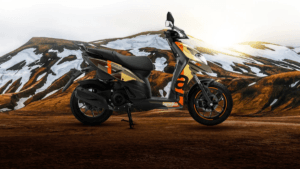 Aprilia SR 175 scooter in camouflage graphics with 14-inch black alloys parked against snowy mountains. Indian commuter.