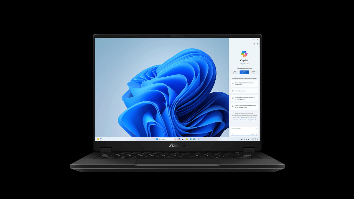 An open black laptop shown from the front with a blue Windows wallpaper and a Copilot artificial intelligence panel open on the side.
