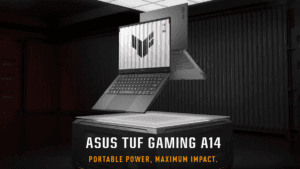 A grey ASUS TUF Gaming A14 laptop floating above a lit platform in a dark warehouse environment, displaying its screen logo.