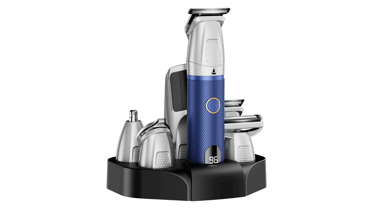 The waterproof grooming kit that fixes your travel charging 3 Blue and silver boAt Slazer K100 Pro trimmer resting on a black storage stand surrounded by multiple grooming attachments.