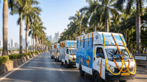 White skill vans with marigold garlands drive on a palm-lined road for the Dell digital skilling launch in India.