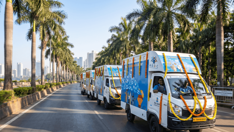 Dell's solar skill vans bring AI training to five states 6 White skill vans with marigold garlands drive on a palm-lined road for the Dell digital skilling launch in India.