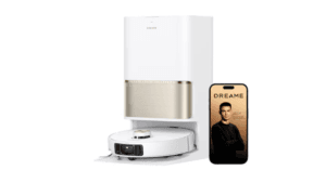 White Dreame robot vacuum in a white and gold dock beside a smartphone showing Cristiano Ronaldo in India.