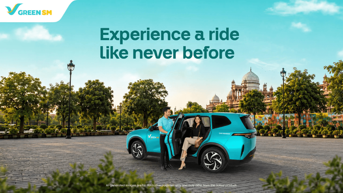 At a 50 percent discount, this EV cab fixes daily commutes 2 Driver in a blue shirt opening a cyan-green electric car door for a passenger near a historical Indian monument.
