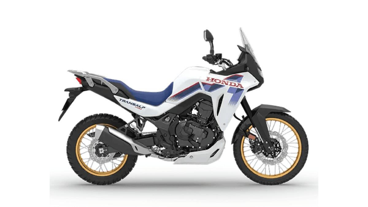 The end of left-hand fatigue in heavy Bengaluru traffic 2 Side profile of a white Honda Transalp motorcycle with gold rims and a blue seat on a white background, sold in India.