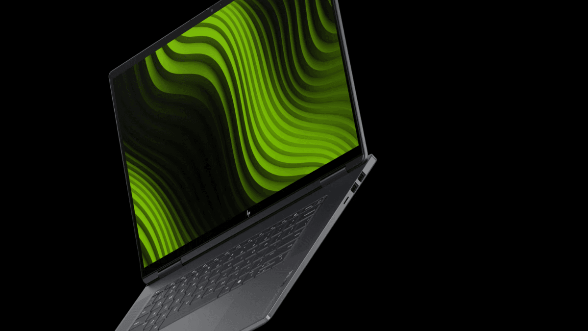 Dark grey laptop angled against a black background displaying a green abstract wave screen, representing new AI hardware.