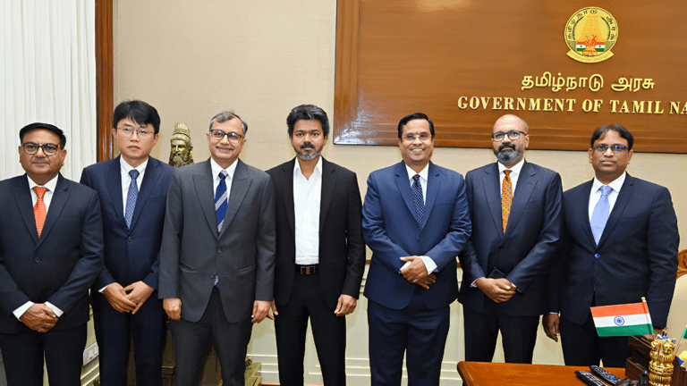 Hyundai is building its massive Indian EV future in Tamil Nadu 2 Seven men in business suits standing inside a Government of Tamil Nadu office during the Hyundai EV hub partnership.