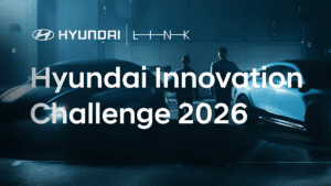 Two people standing between cars in a dimly lit garage below the Hyundai Innovation Challenge 2026 text for Indian startups.