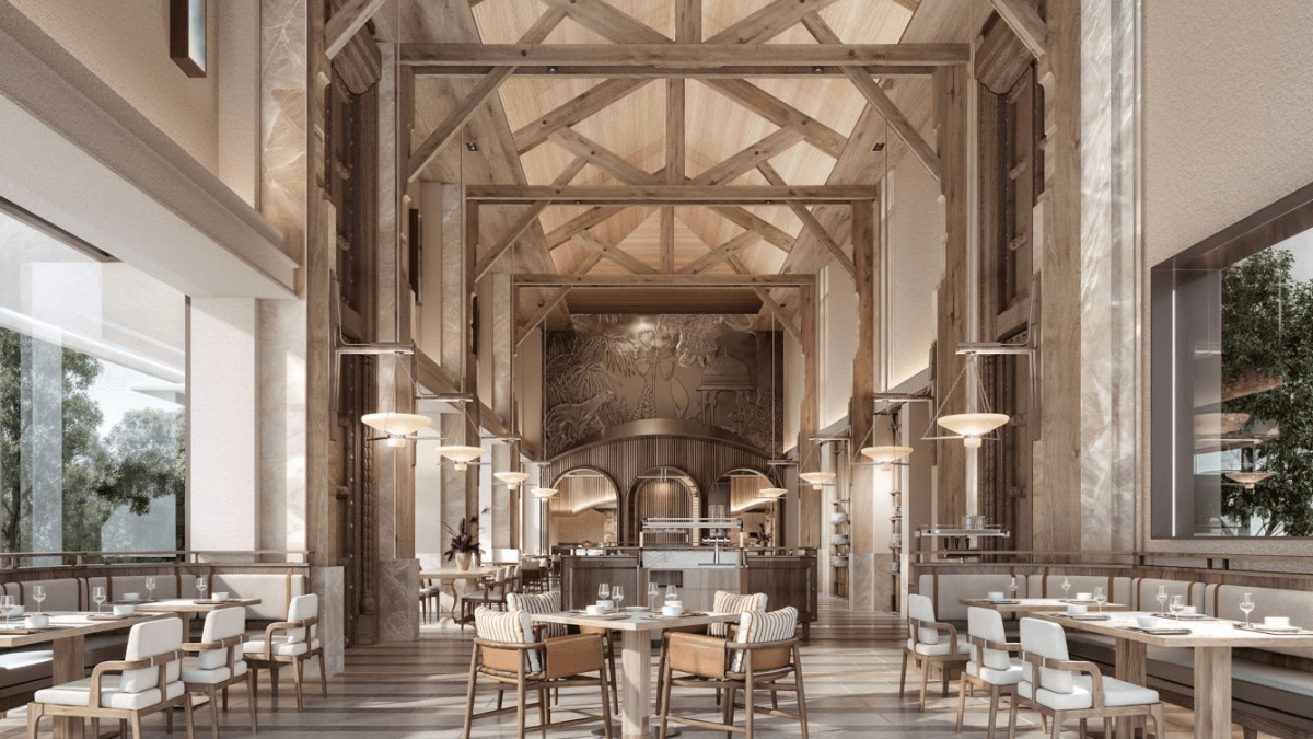 A luxury Rajasthan getaway built for family safaris 3 An upscale restaurant dining room with soaring wooden vaulted ceilings, pillar accents, and neatly set tables.