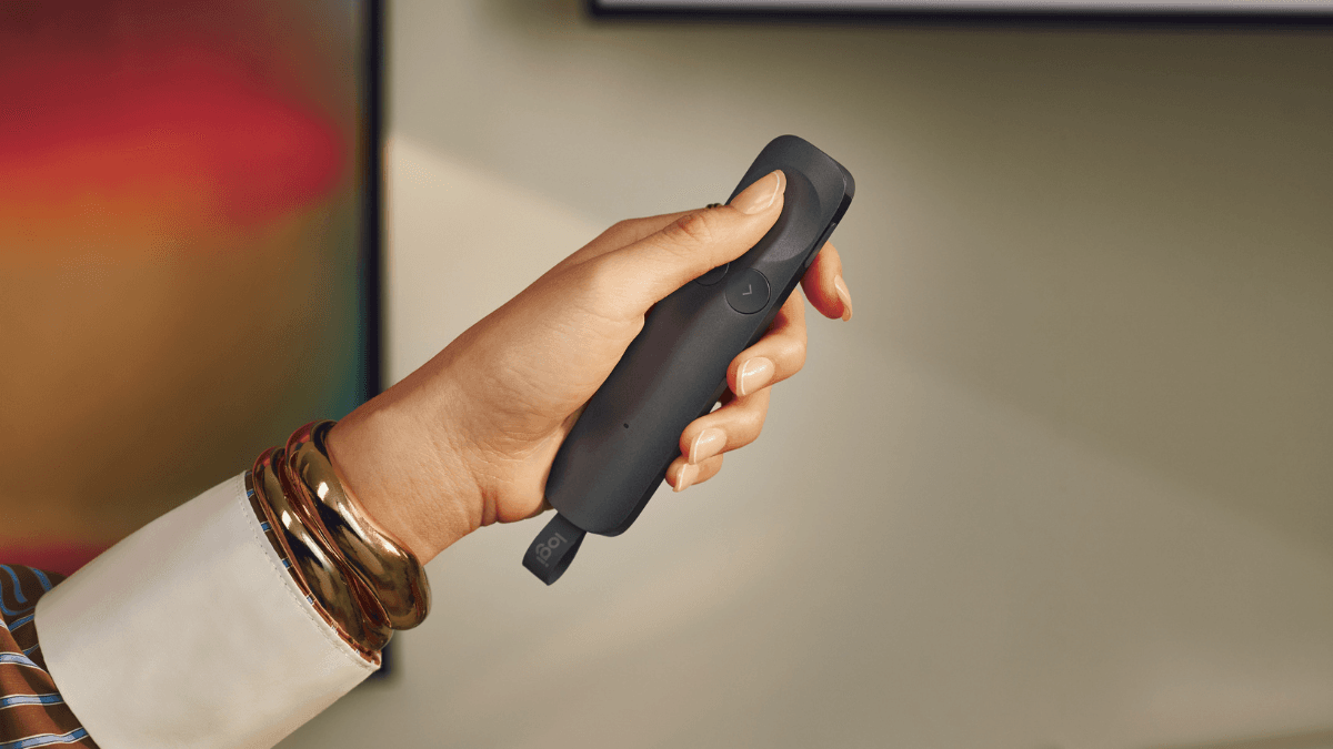 The new device that could cure your presentation nerves 1 Hand holding a sleek dark grey Logitech Spotlight 2 presentation remote control highlighting its ergonomic force sensitive...