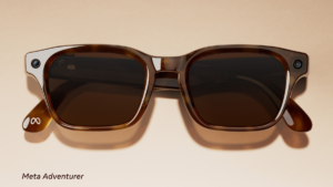 Tortoiseshell rectangular spectacles with corner camera lenses on a beige background, displaying the Adventurer style.