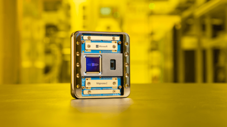 Microsoft's new quantum chip is 1,000 times more reliable 3 The gold-cased Microsoft Majorana 2 quantum chip sitting on a surface in a yellow-lit lab, marking a leap in AI research.