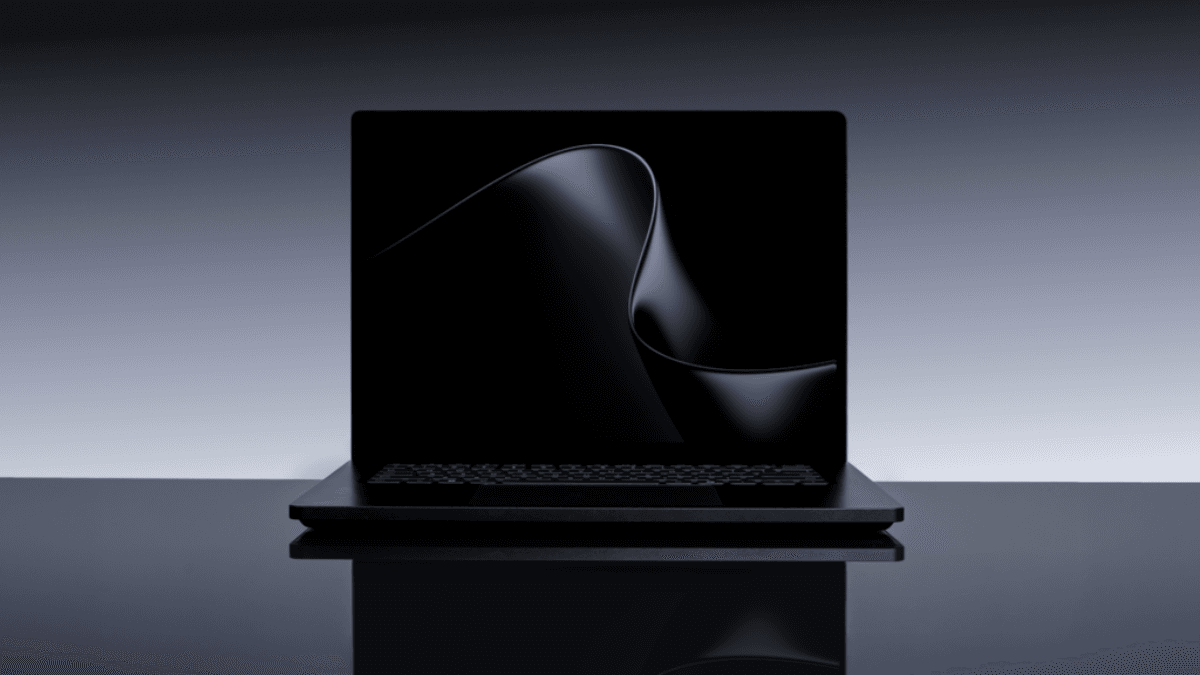 The hardware leap that changes local AI processing forever 1 A black laptop open on a glossy surface displaying a smooth dark wave on screen, previewing premium Windows hardware.