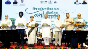 Officials on stage holding the Working Plan at a Delhi park launch.