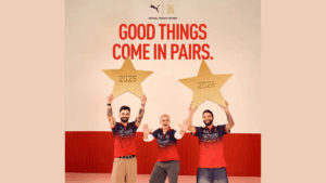 Virat Kohli and Rajat Patidar holding large gold stars next to Jacob Bethell in red cricket jerseys for an RCB campaign.