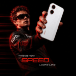 A man wearing sunglasses holding a white smartphone against a dark background with red speed lines in India.