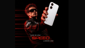 A man wearing sunglasses holding a white smartphone against a dark background with red speed lines in India.