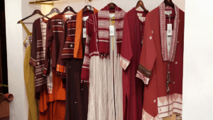 Traditional embroidered garments hanging on a clothing rack inside the premium RISA retail store.