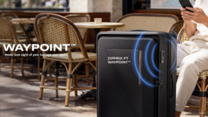 Black suitcase with blue signal waves next to a person holding a smartphone at an outdoor café, illustrating tracking.