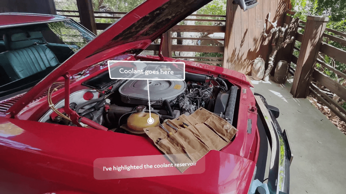 The AR glasses that aim to turn your entire world into a workspace 2 A car engine under repair with an AR digital overlay labeling the coolant reservoir, demonstrating spatial AI guidance.