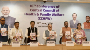 Indian health ministers stand left to right holding copies of the SUMAN Roadmap 2030 booklet at a conference.