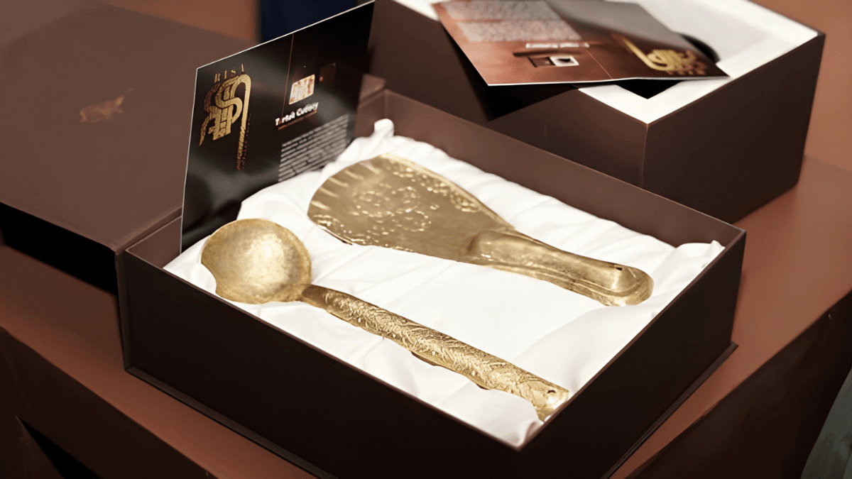 TRIFED opens a premium tribal textile store in New Delhi 3 Engraved brass spoon and spatula inside a satin-lined premium box showing the RISA Ladakh cutlery collection.