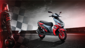 Rider holding a helmet on the left looks at a grey and red scooter on a racetrack background, Ntorq context.