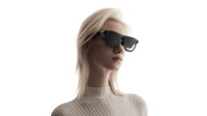 Blonde woman wearing black XREAL Aura glasses in profile against a white background, showcasing the lightweight design.