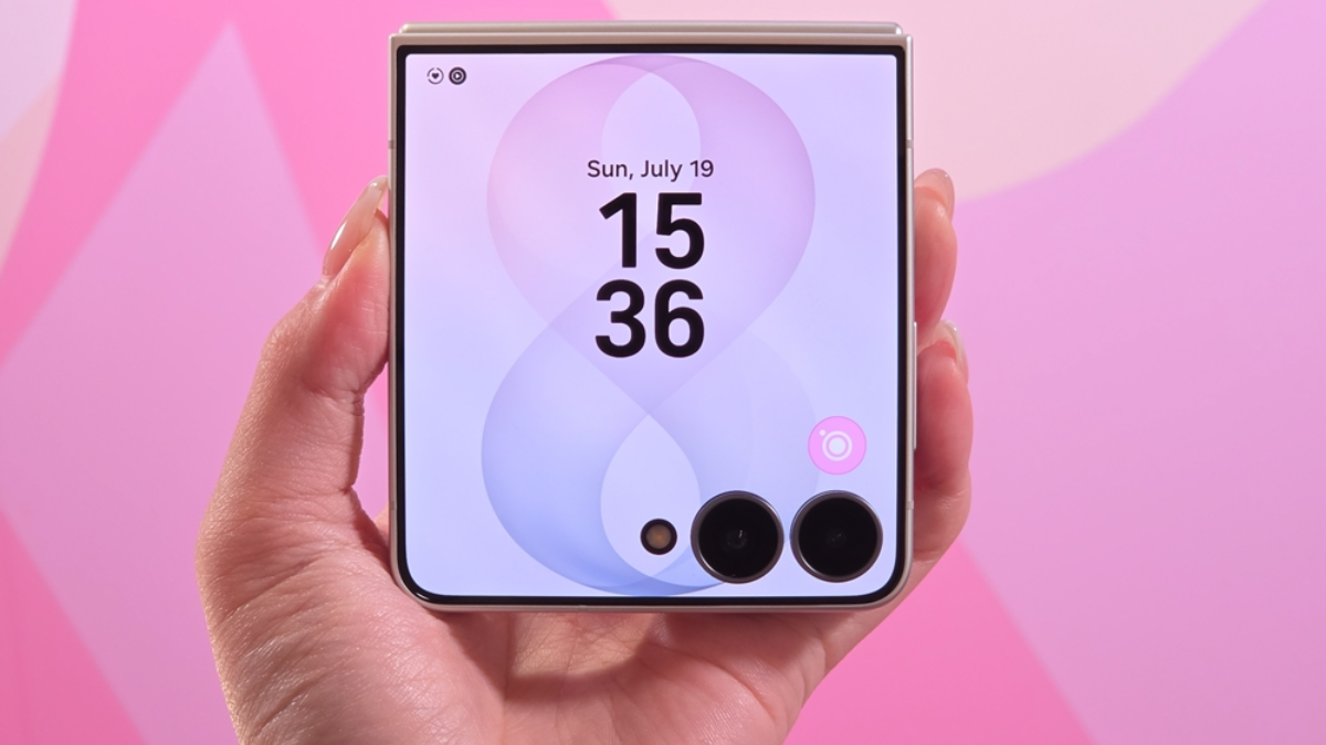 Can a 4.1-inch cover display stop you from unfolding? 1 Hand holding closed foldable phone showing clock display on cover screen against pink background. FlexWindow.