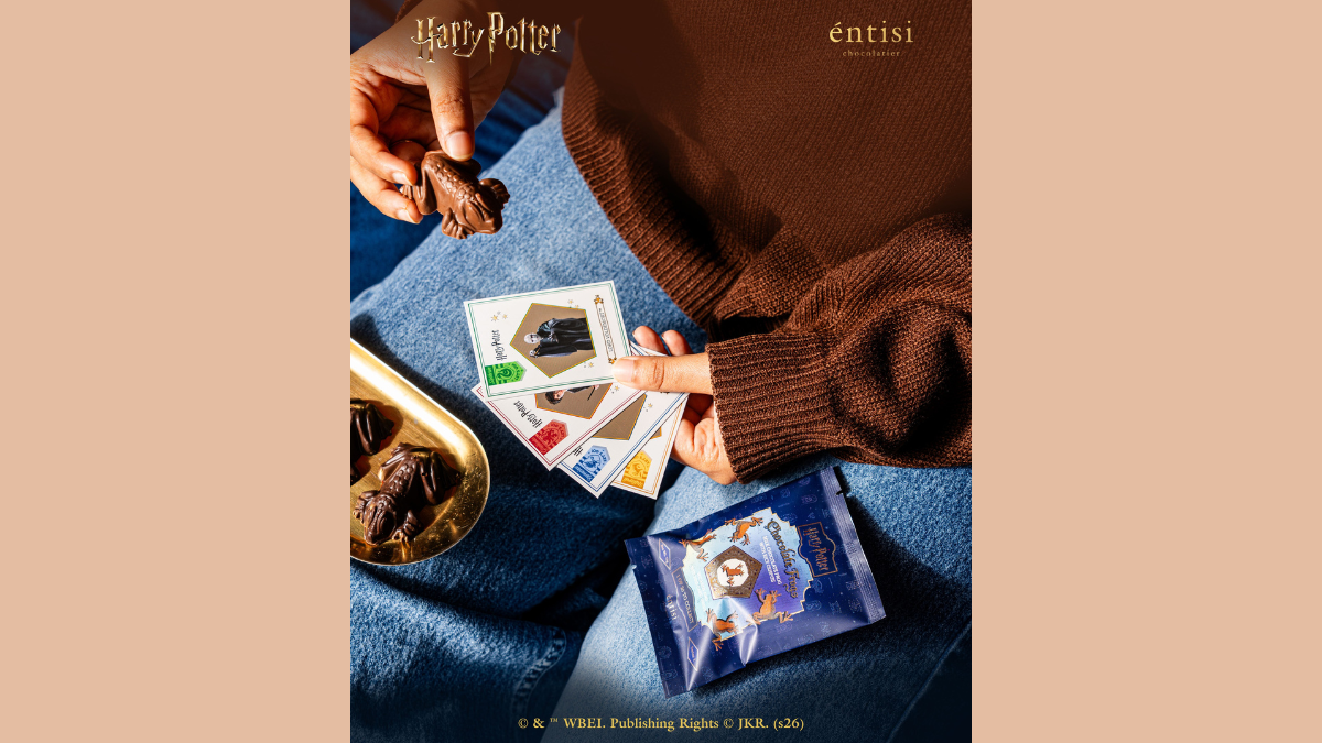 Official wizarding chocolates hit Blinkit starting at Rs. 129 2 Frog chocolate held in hand, pentagonal character cards, blue sachet, gold dish with chocolate frog merchandise.