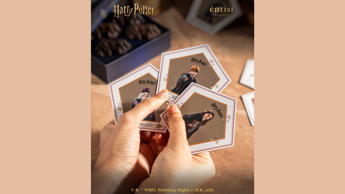 Official wizarding chocolates hit Blinkit starting at Rs. 129 3 Hands holding pentagonal character cards featuring Dumbledore, Ron, and Hermione, dark chocolate box merchandise.